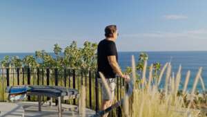 Michael Baldwin, a founding member of Del Mar Real Estate, standing on a Palmilla property balcony overlooking the Sea of Cortez.
